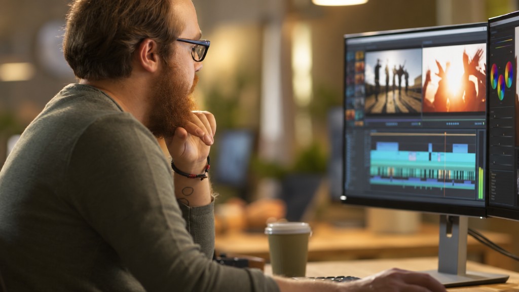 A man reviews a video edit across two monitors